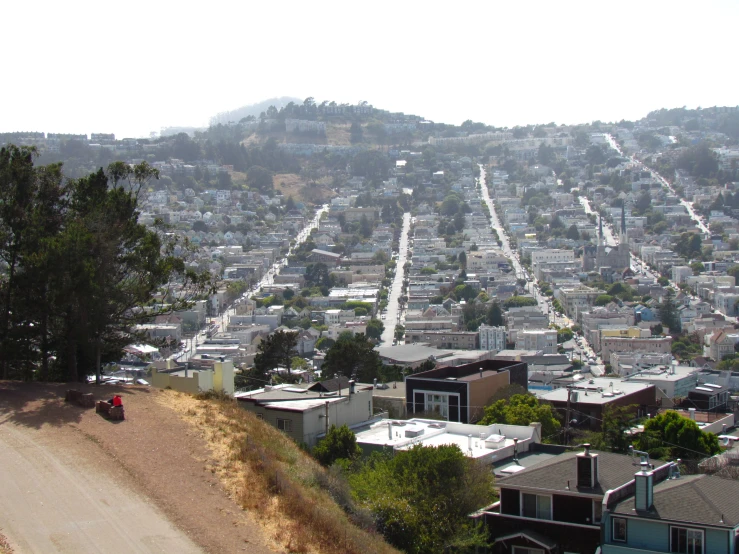 a street lined with small houses next to a hillside