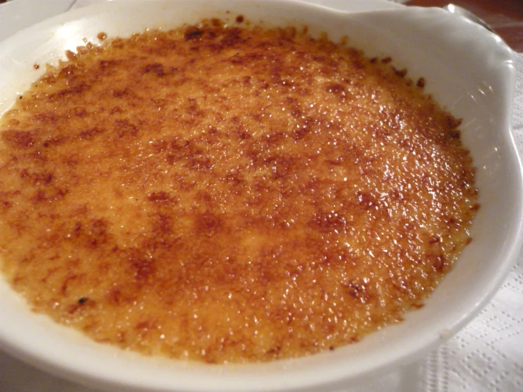 a small bowl filled with sauce on top of a white plate