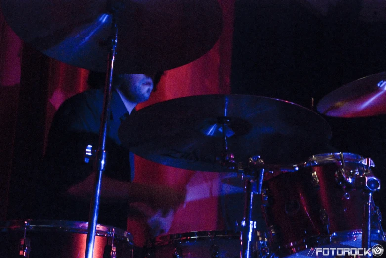 the drummer is playing drums on stage