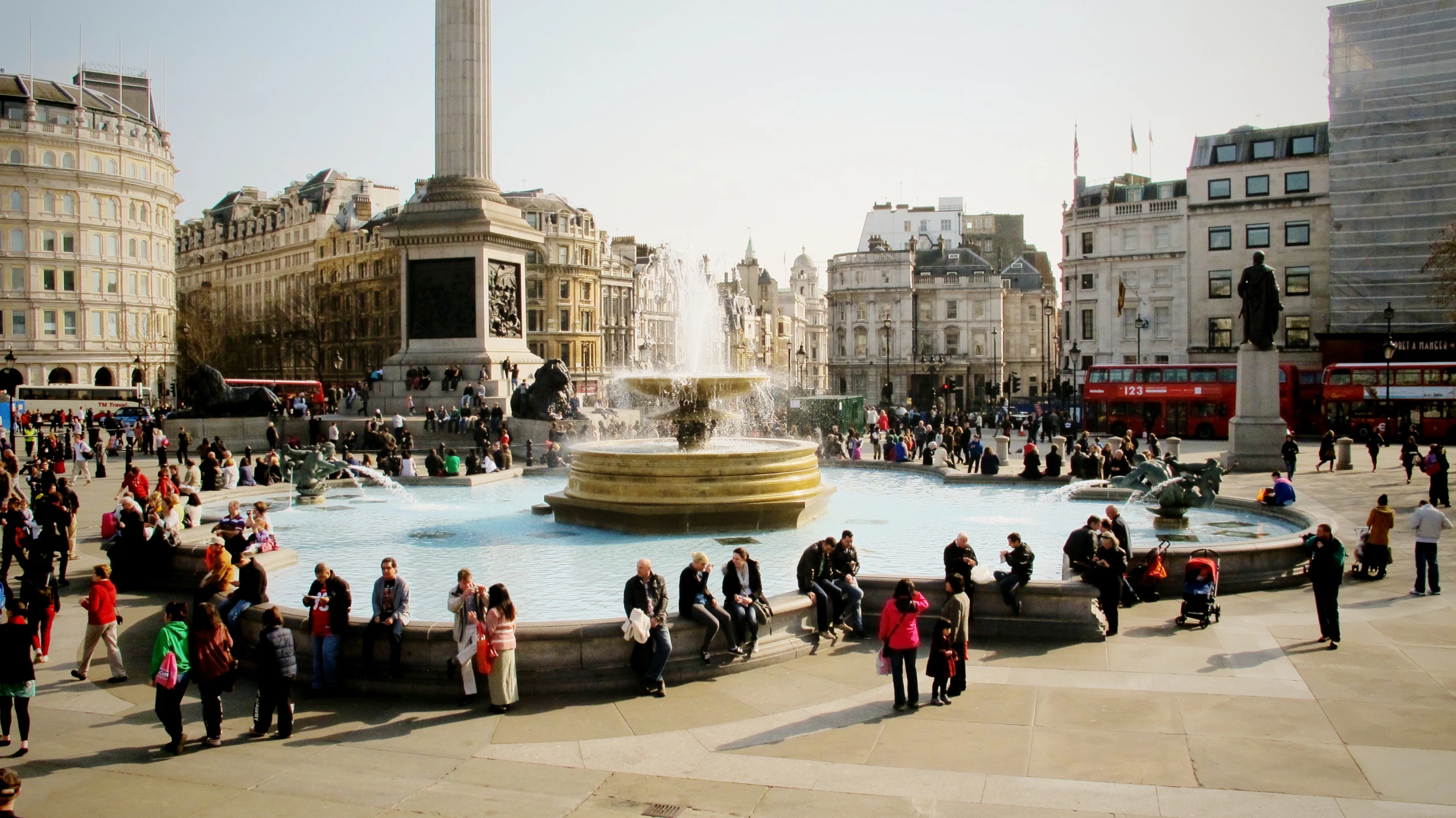 there is a fountain with people gathered around it