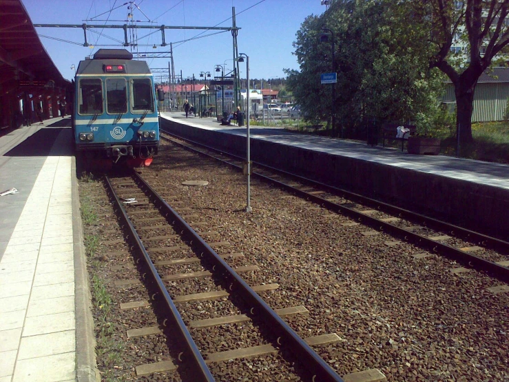 a train is on the train tracks near a platform