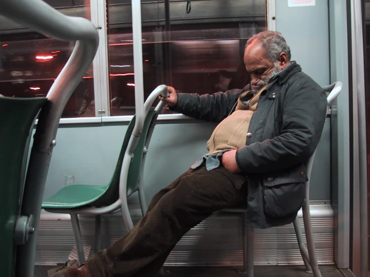 a man sitting on the subway bench