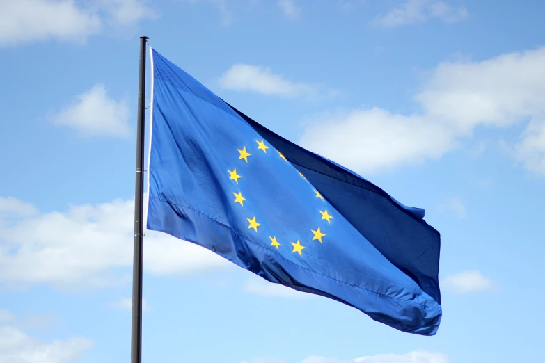 an european flag flies high on a clear day