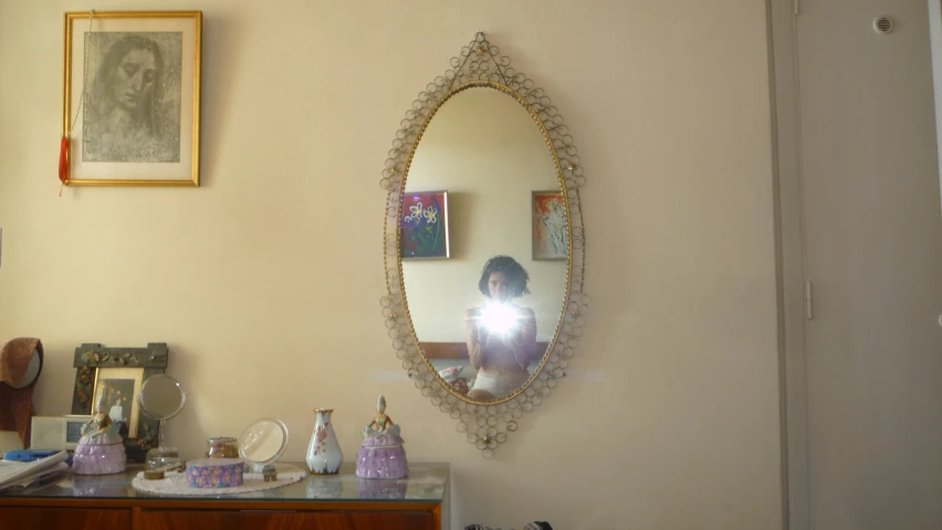 a dresser with a mirror and other items next to it