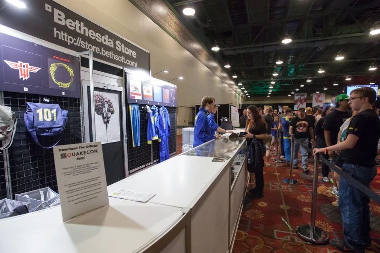 people in a convention room near a shelf