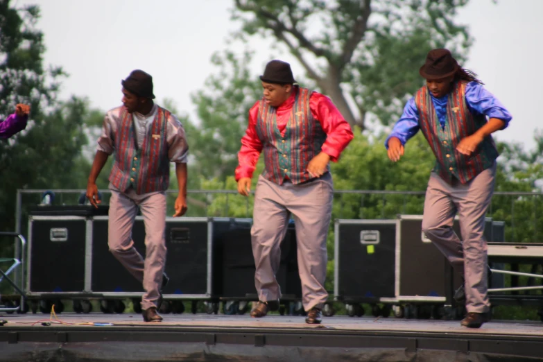 men on stage dancing and some singing