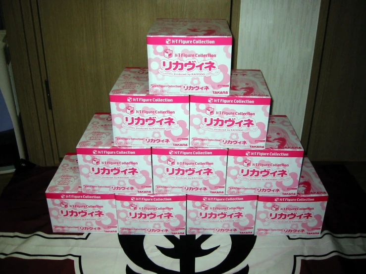 several pink boxes stacked in the shape of a tree on top of a table