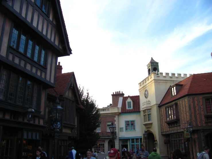 many people walk along side a row of buildings