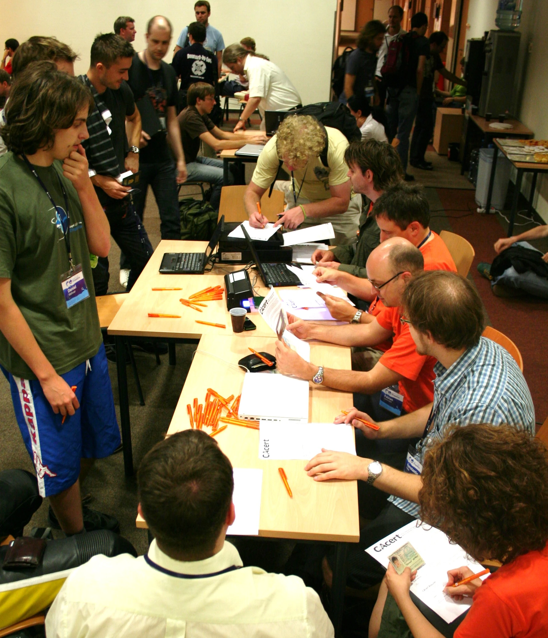 several people sitting at desks in a building