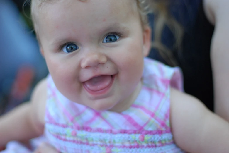 the baby has big blue eyes and smile