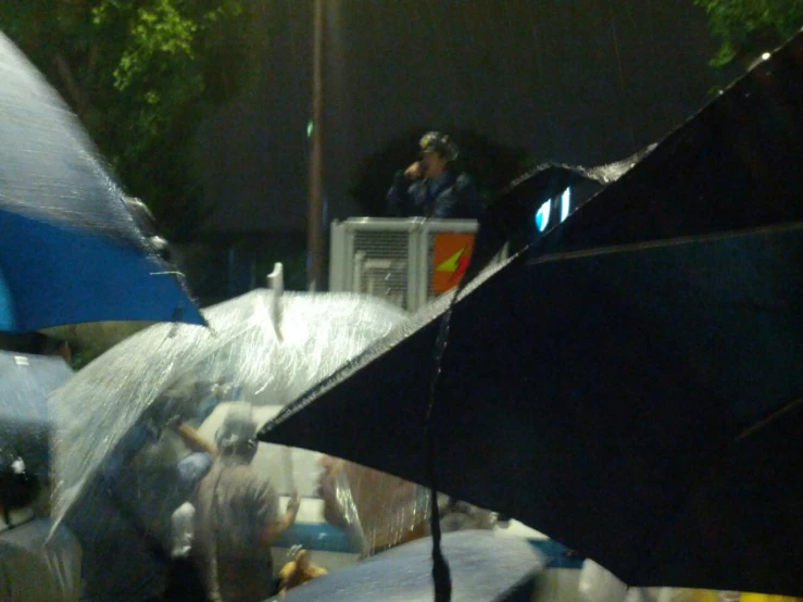 a crowd watches as an umbrella goes up high