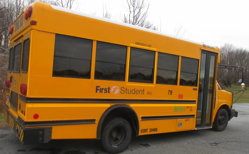 the school bus has the first student written on the front window