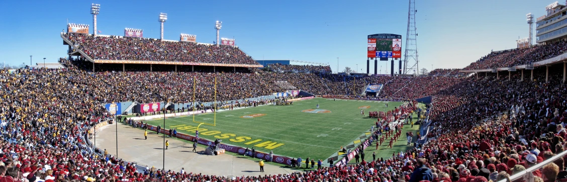 a full stadium with several large fans watching a game