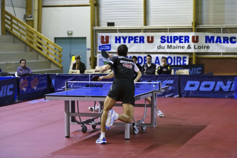 a group of table tennis players playing tennis