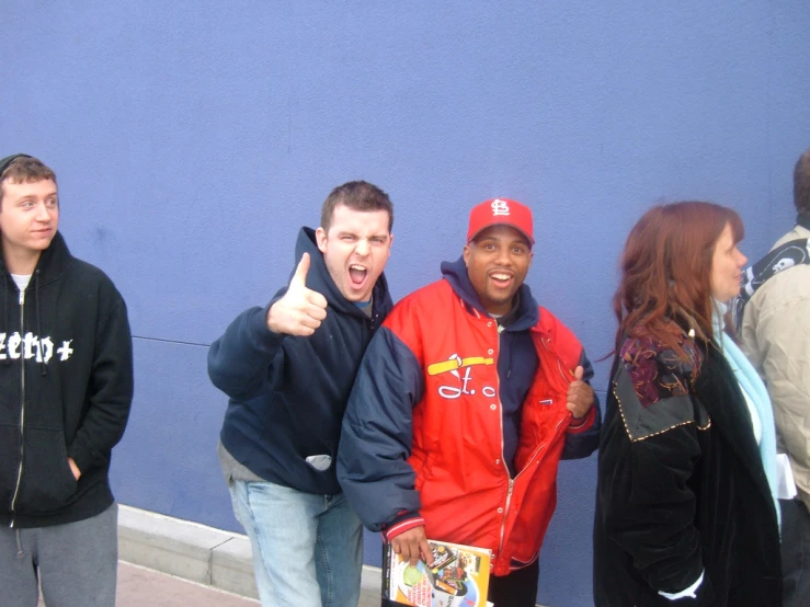 five boys standing next to each other and one girl giving the thumbs up