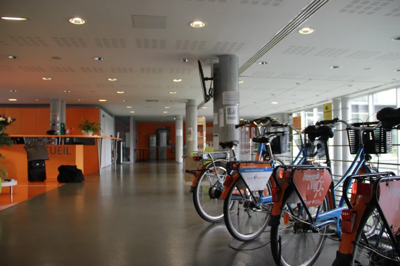 the inside of a building with lots of bicycles on display