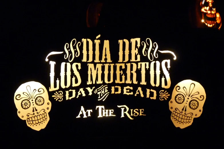 a neon sign that reads dia de los muerttos at the isle