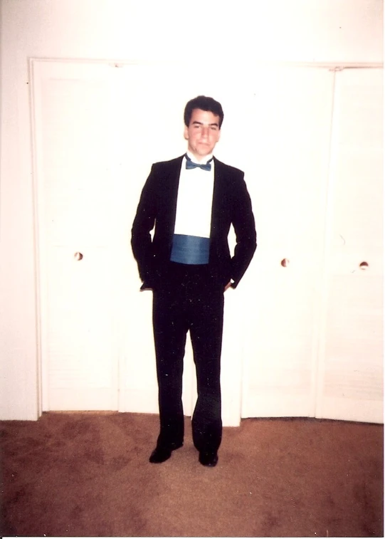 man in suit standing in front of the door