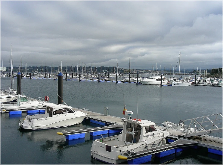 the boats are parked in the dock and have a sky background