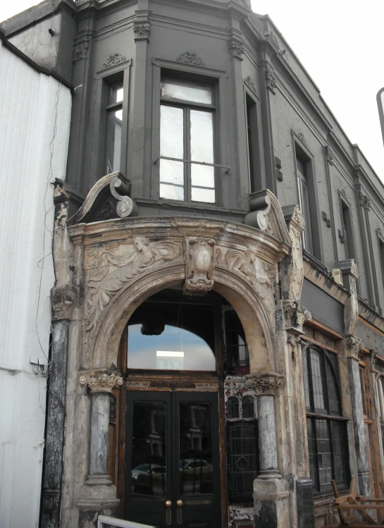 an old building with a very big arched door