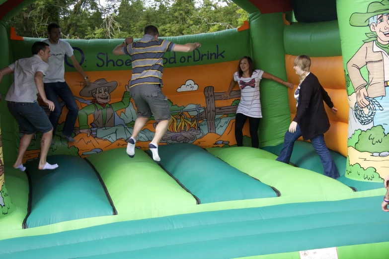 people jump on top of a bouncy castle inflatable