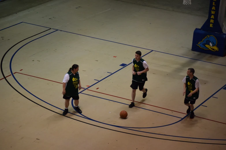 there are young men playing a game on a basketball court