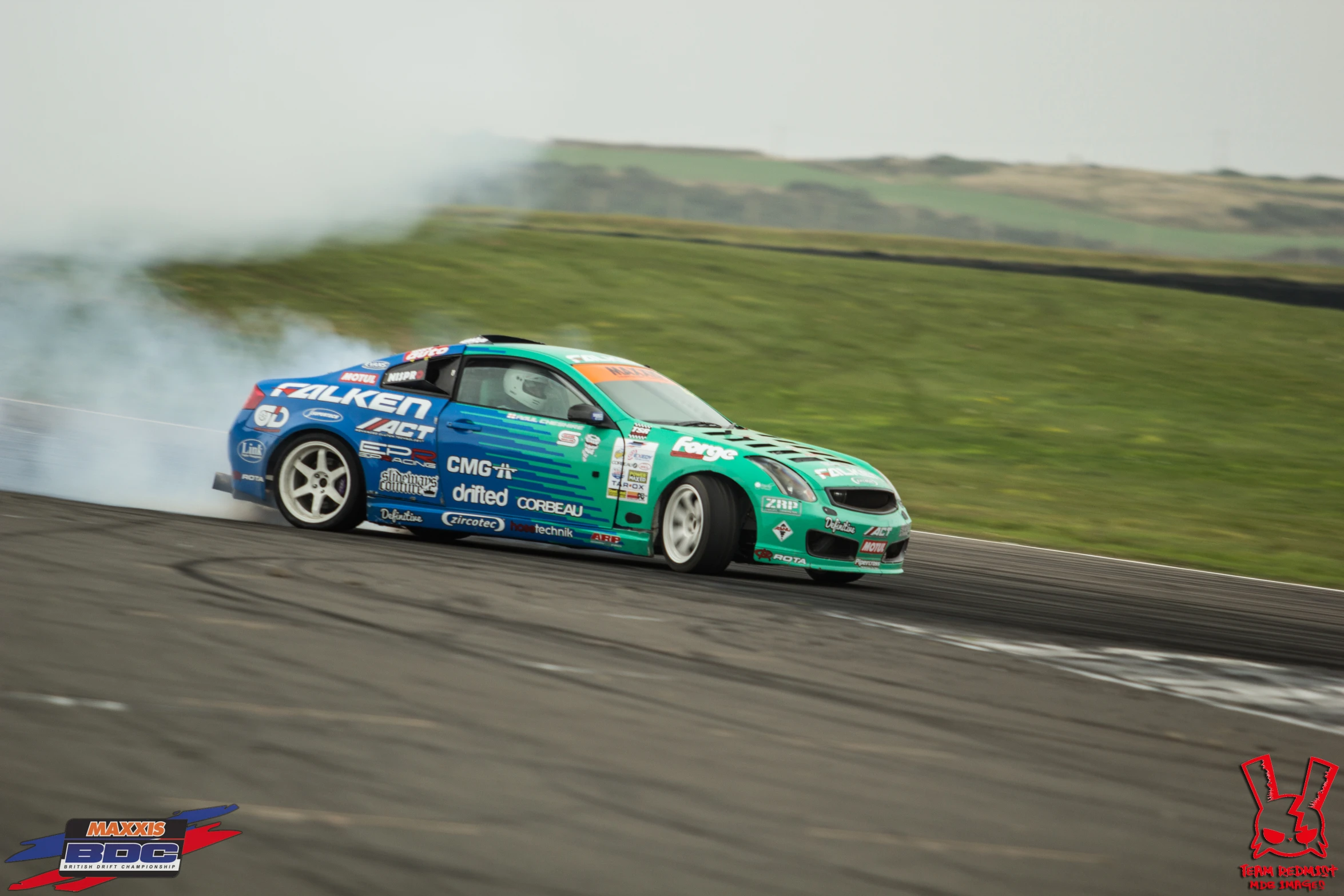 a person on a racing car blowing out the smoke