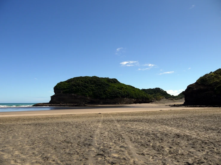 some rocks by the water and sand