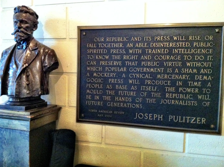 statue of joseph pullzer with plaque in museum