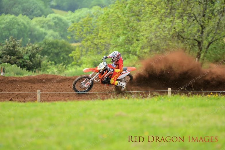 a man on a motorcycle riding through the dirt