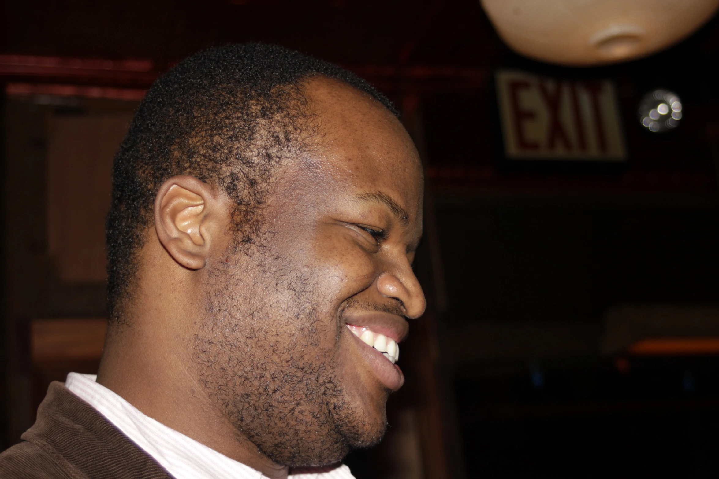 a young man smiling in a business tie