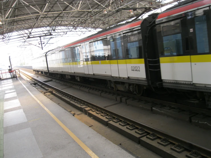 train pulling into train station with no people on the platforms