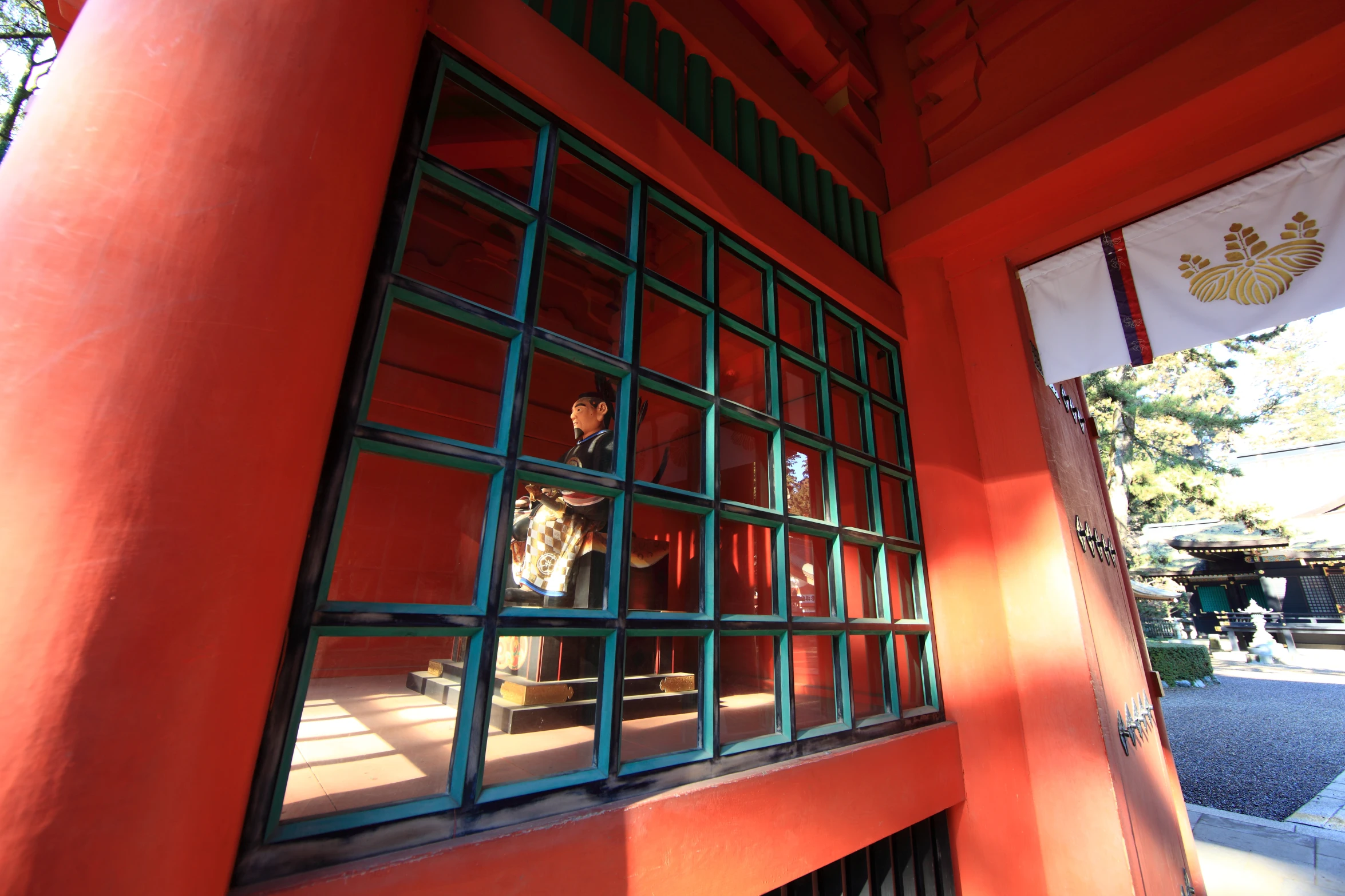 the red wall is full of windows as well as a flag