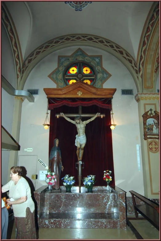 a cross sitting on top of a wooden table in a church