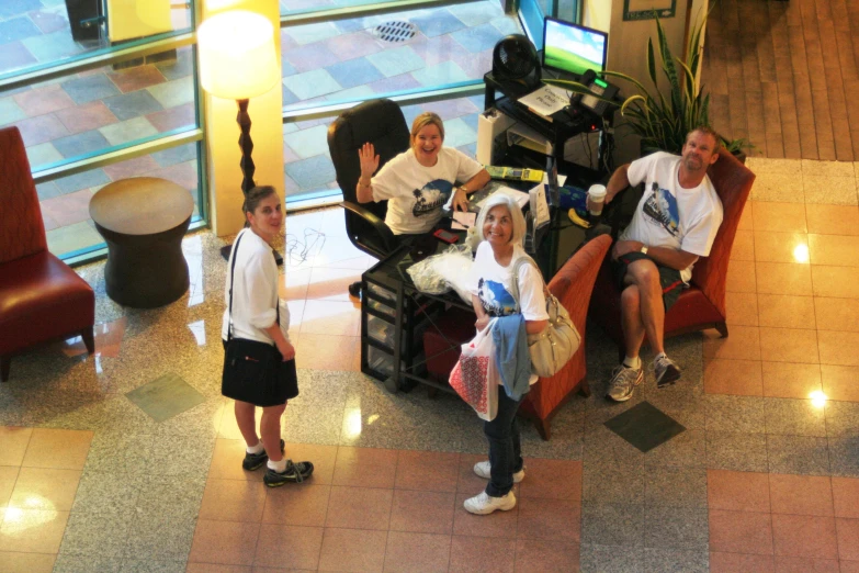 four people sitting down and posing for a po