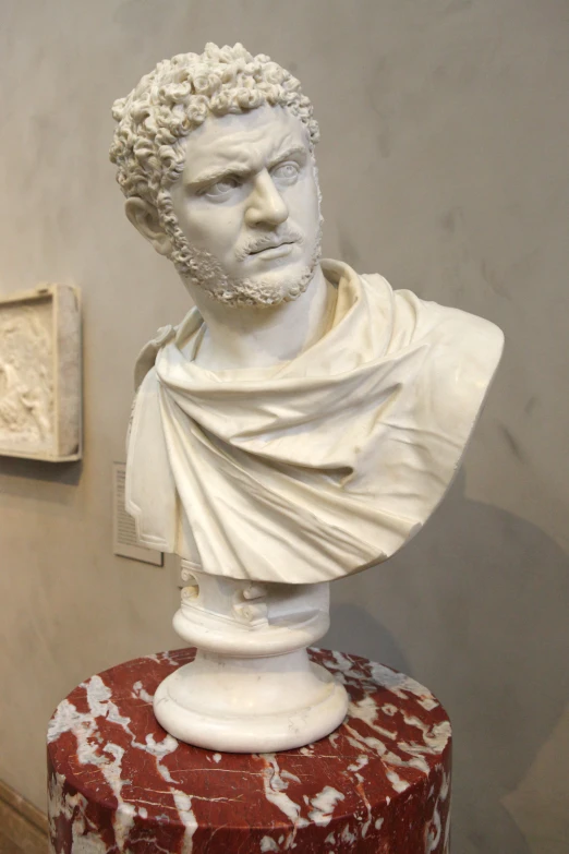 a bust of a man with an embellishment on its face