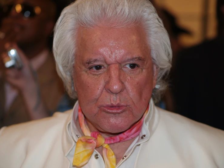 an older man wearing a yellow and pink bow tie