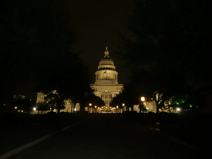 a large building with a lighted up dome in the dark