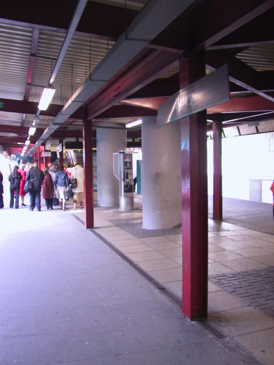 people are walking through the long, empty building