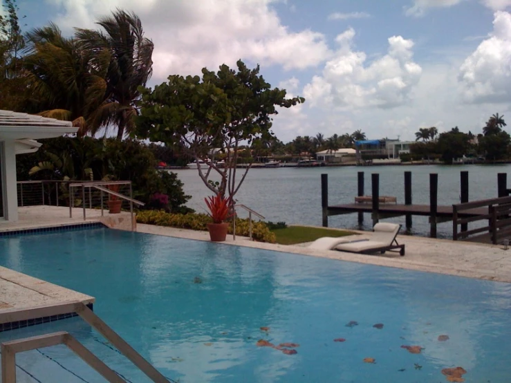 the pool and deck on the other side of the lake