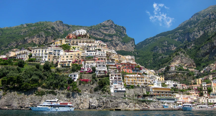 several buildings along a rocky shoreline on a sunny day