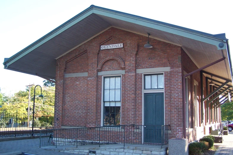 a brick building with two doors and a second one at the top of it