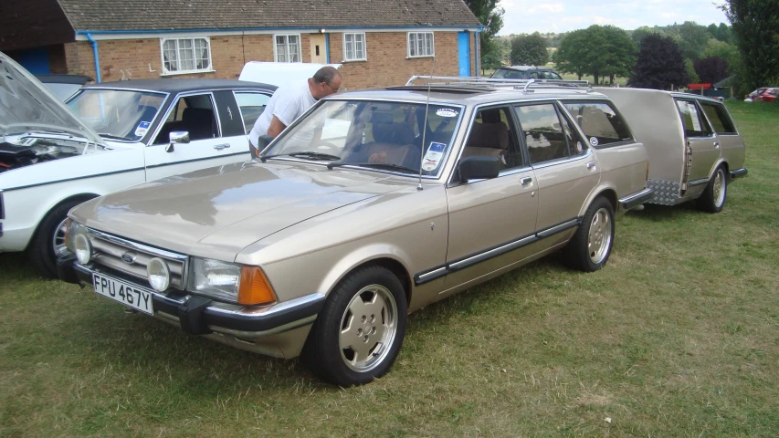 a grey and white car parked next to a house