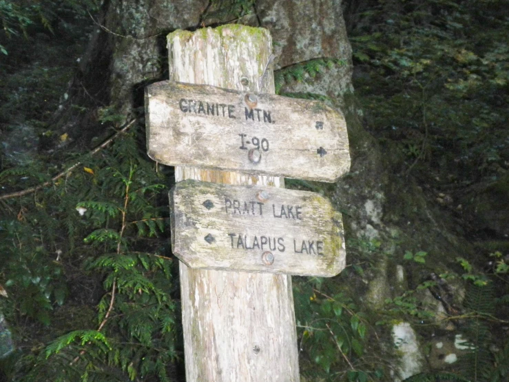 wooden sign points to a variety of different trails