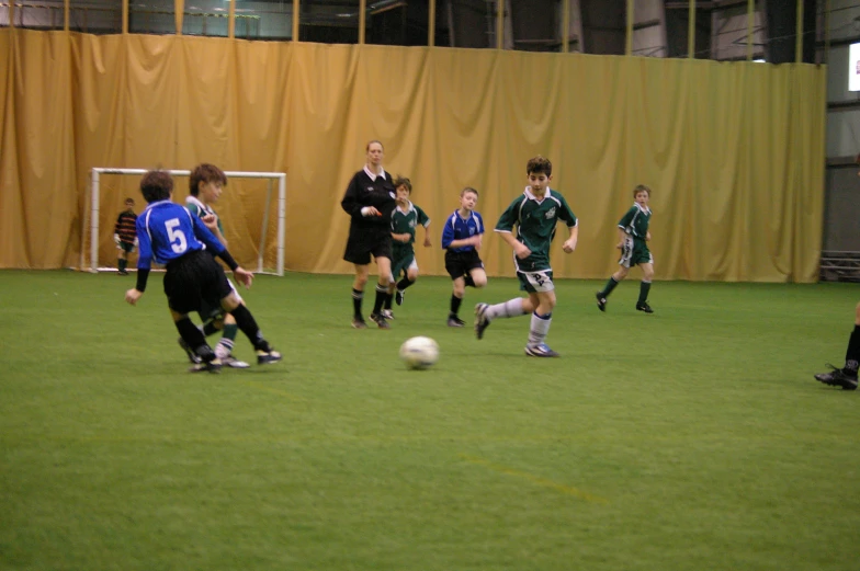 two teams competing to take the ball in a soccer game