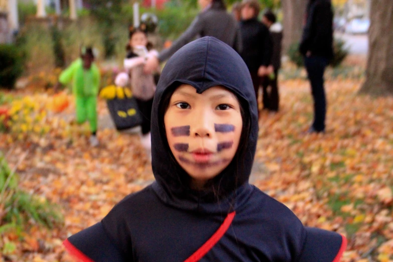 a young child with some make - up on their face and body