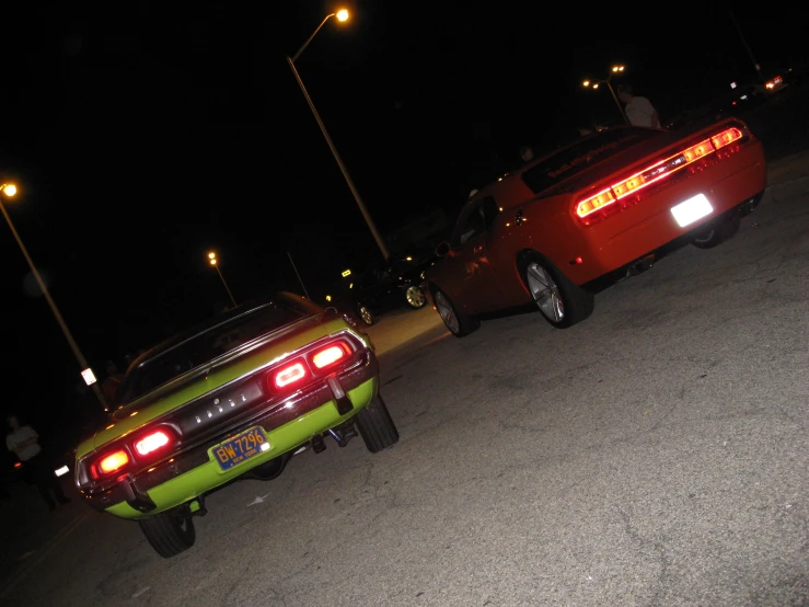 two cars parked next to each other at night