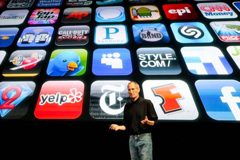 the man standing in front of the large display of apps