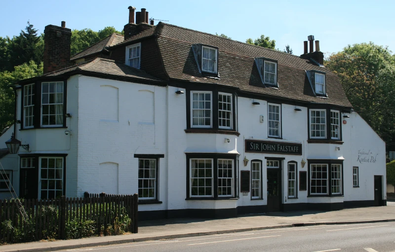 a white building with two story windows and several chimneys