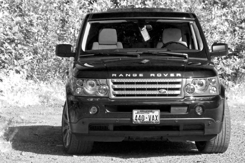 black and white pograph of an suv on the road